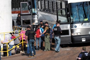 Workers from a Koch Foods plant being taken away by ICE agents during a raid, Morton, Mississippi, August 7, 2019